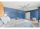 Bright bedroom featuring a wooden accent wall, and modern ceiling fan at 6975 S Wadsworth Ct, Littleton, CO 80128