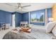 Well-lit bedroom with hardwood accent wall, and a comfortable bed at 6975 S Wadsworth Ct, Littleton, CO 80128