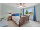 Bright and comfortable bedroom with large window, beautiful view, and wooden bed frame at 6975 S Wadsworth Ct, Littleton, CO 80128