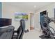 Home office with mountain view art, desk, ergonomic chair, doorway, and workout machine at 6975 S Wadsworth Ct, Littleton, CO 80128