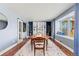 Dining room features a bay window seat, a large window, and an adjacent workspace with sliding glass doors at 6975 S Wadsworth Ct, Littleton, CO 80128