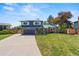 Charming two-story home with well-maintained lawn and beautiful landscaping at 6975 S Wadsworth Ct, Littleton, CO 80128