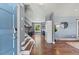 Open foyer with hardwood floors, staircase and views to the living spaces at 6975 S Wadsworth Ct, Littleton, CO 80128