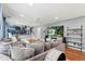 Spacious living room with hardwood floors and a comfortable sectional sofa, open floor plan at 6975 S Wadsworth Ct, Littleton, CO 80128