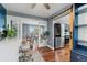 Open-concept view from office to kitchen featuring modern appliances and a dining table at 6975 S Wadsworth Ct, Littleton, CO 80128