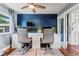 Well-appointed office featuring a built-in desk, ceiling fan and modern decor at 6975 S Wadsworth Ct, Littleton, CO 80128