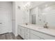 Bathroom with double sinks, vanity with storage and large mirror, next to an enclosed glass shower at 487 Interlocken Blvd # 409, Broomfield, CO 80021
