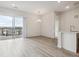 Bright living space with luxury vinyl plank flooring and a sliding glass door with balcony access at 487 Interlocken Blvd # 409, Broomfield, CO 80021