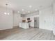 Open-concept living space with modern kitchen, sleek appliances, pendant lighting, and durable vinyl flooring at 487 Interlocken Blvd # 409, Broomfield, CO 80021