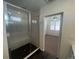 Contemporary bathroom boasts a glass shower and a doorway leading into a carpeted bedroom at 3404 W 18Th Ave, Denver, CO 80204
