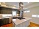 Bright kitchen featuring stainless steel appliances, a center island cooktop, and hardwood flooring at 3404 W 18Th Ave, Denver, CO 80204