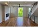 Bright living room with modern fireplace, hardwood floors, and door to balcony at 3404 W 18Th Ave, Denver, CO 80204