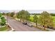 Street view with parked cars and a large athletic field at 3404 W 18Th Ave, Denver, CO 80204