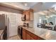 Galley kitchen with granite countertops and wood cabinets at 1255 N Ogden St # 701, Denver, CO 80218