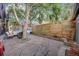 Backyard with stone pavers, a wooden fence and mature tree at 249 S Lincoln St, Denver, CO 80209