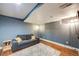 Finished basement with a gray sofa, hardwood floors, recessed lighting, and an accent wall at 249 S Lincoln St, Denver, CO 80209