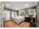 Spacious bedroom with hardwood floors, two closets, and natural light from the two windows at 249 S Lincoln St, Denver, CO 80209