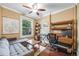 Cozy bedroom featuring a ceiling fan, a comfortable gray sofa, and hardwood floors at 249 S Lincoln St, Denver, CO 80209