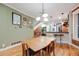 Inviting dining area with hardwood floors and a modern light fixture next to the kitchen bar area at 249 S Lincoln St, Denver, CO 80209