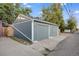 Two car garage with gray siding and a concrete driveway at 249 S Lincoln St, Denver, CO 80209