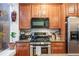 Well-equipped kitchen features stainless steel appliances, granite countertops, and wood cabinets at 249 S Lincoln St, Denver, CO 80209