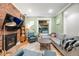 Cozy living room with exposed brick wall, fireplace, comfortable seating, and natural light at 249 S Lincoln St, Denver, CO 80209