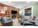 Comfortable living room featuring exposed brick, an open floor plan, and an abundance of natural light at 249 S Lincoln St, Denver, CO 80209