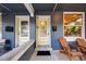Charming front porch with decorative glass doors, Adirondack chairs and brick facade at 249 S Lincoln St, Denver, CO 80209