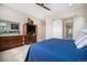 Comfortable bedroom with sliding barn door, dresser, and carpet at 11168 Sweet Cicely Dr, Parker, CO 80134