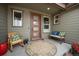 Inviting front porch offers a cozy seating area with a rocking chair, bench, and charming decor at 11168 Sweet Cicely Dr, Parker, CO 80134