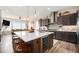 Bright, open kitchen features a large island with seating, stainless appliances and views of the living room at 11168 Sweet Cicely Dr, Parker, CO 80134