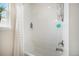 Bright shower featuring white subway tiles and a convenient shelving niche for toiletries at 11168 Sweet Cicely Dr, Parker, CO 80134
