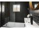 Modern bathroom featuring hexagon tile, glass shower door, and round mirror at 1755 Ingalls St, Lakewood, CO 80214