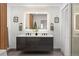 Modern bathroom featuring a double vanity, sleek black fixtures, and unique pendant lighting at 1755 Ingalls St, Lakewood, CO 80214