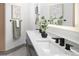 Modern bathroom featuring an extended countertop with dual sinks and matte black hardware at 1755 Ingalls St, Lakewood, CO 80214