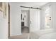 Bedroom featuring a large sliding barn door leading to the en-suite bath at 1755 Ingalls St, Lakewood, CO 80214
