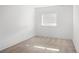 Bare bedroom featuring neutral walls and carpet, with a sun-filled window view at 1755 Ingalls St, Lakewood, CO 80214