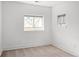 Bright bedroom features neutral carpet, white walls, and a pair of windows at 1755 Ingalls St, Lakewood, CO 80214