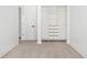 Walk-in closet featuring an organized shelving system with hanging space, drawers, and a crisp white door at 1755 Ingalls St, Lakewood, CO 80214