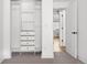 Open closet with built-in shelving and drawers adjacent to the bedroom at 1755 Ingalls St, Lakewood, CO 80214