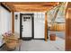 Inviting seating area and front door under a pergola, enhanced by a potted plant at 1755 Ingalls St, Lakewood, CO 80214