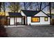 Charming exterior of a white home with black trim, pergola, and a daylight sky at 1755 Ingalls St, Lakewood, CO 80214
