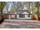 Charming exterior of a white home with black trim, a pergola, and large gravel area at 1755 Ingalls St, Lakewood, CO 80214