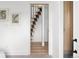Hallway view of a floating wood staircase and a stylish wood slat accent wall at 1755 Ingalls St, Lakewood, CO 80214