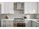 Close up of the modern kitchen featuring stainless steel appliances and light gray subway tile backsplash at 1755 Ingalls St, Lakewood, CO 80214