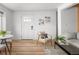 Open-concept living area with light wood floors and minimalist decor for a bright and airy feel at 1755 Ingalls St, Lakewood, CO 80214