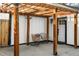 A pergola with decorative wooden beams with seating, a potted plant, and front door at 1755 Ingalls St, Lakewood, CO 80214