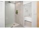 Walk-in shower with modern tile surround, rain shower head and a view into the bedroom at 1755 Ingalls St, Lakewood, CO 80214