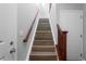 Staircase with wood stairs and railings at 12941 Grant W Cir # C, Thornton, CO 80241