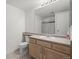 Neutral bathroom featuring a vanity with sink, toilet, and shower at 710 Copper Ln # 102, Louisville, CO 80027